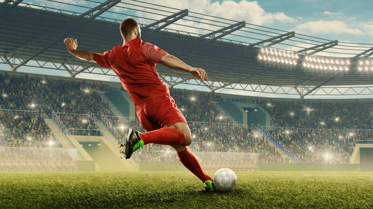 Soccer Player Kicking The Ball