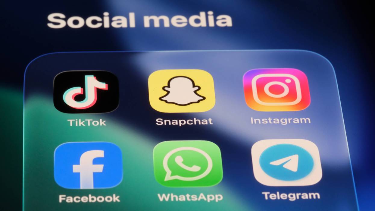 Social media app icons on a phone screen: TikTok, Snapchat, Instragram, Facebook, WhatsApp and Telegram