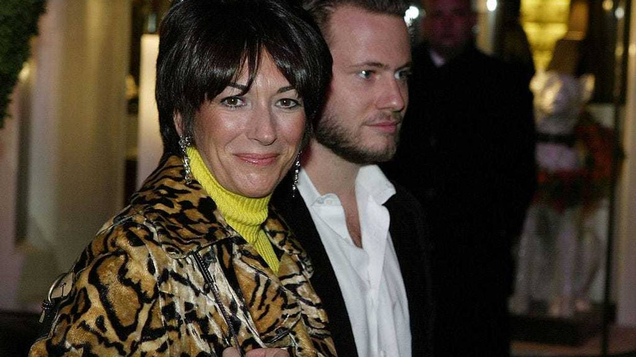 Socialite Ghislane Maxwell with an unidentified male companion attends the Opening of the Asprey Flagship Store on 5th Avenue December 8, 2003 in New York City. (Photo by Mark Mainz/Getty Images)