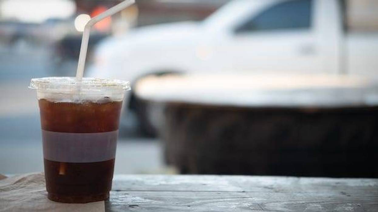 Soda in a plastic cup with a straw