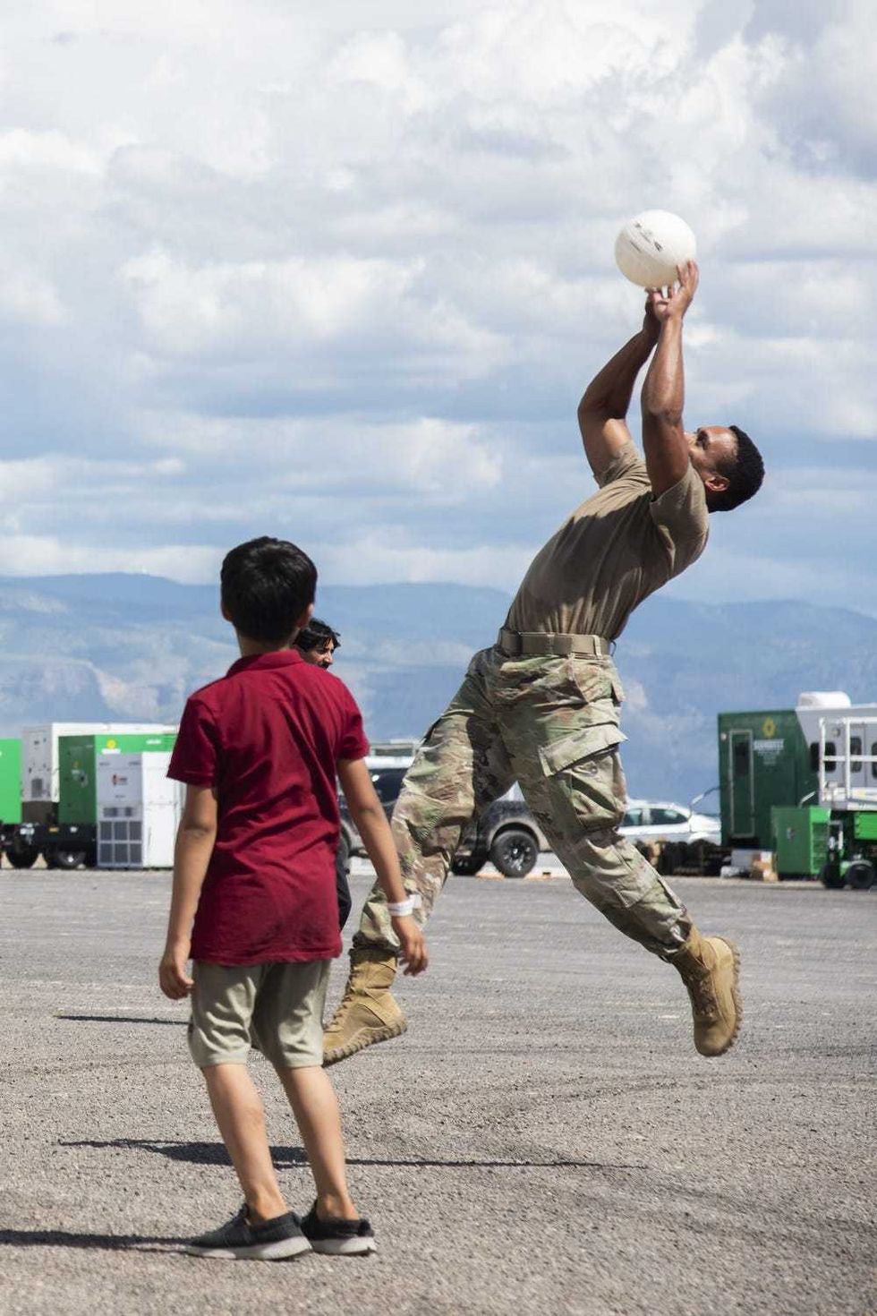 Soldiers playing with Afghan kids