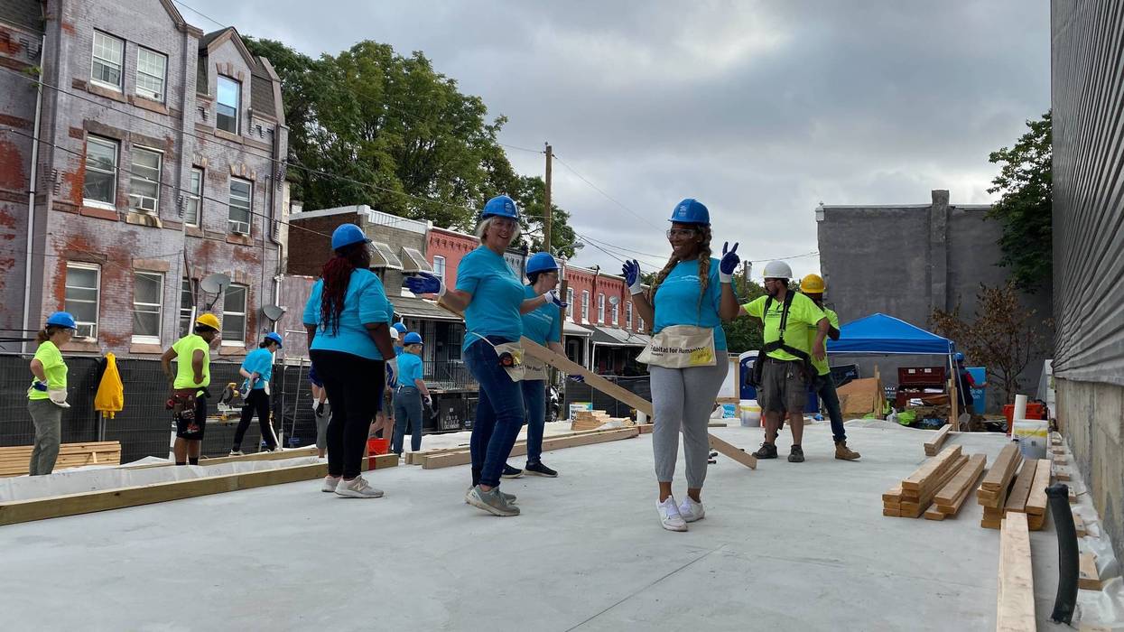 Some of the women from the volunteer builder crew work on the first of four houses going up in Mantua.