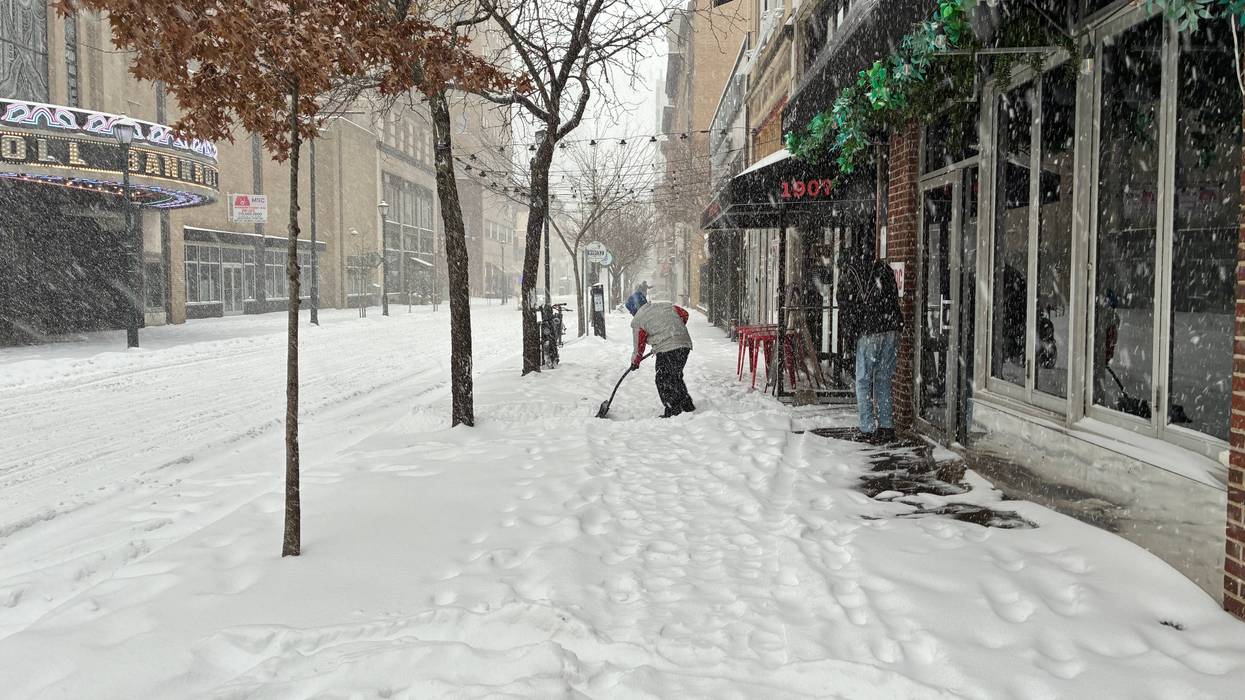 Someone shovels the sidewalk on Chestnut Street near Rittenhouse Square.
