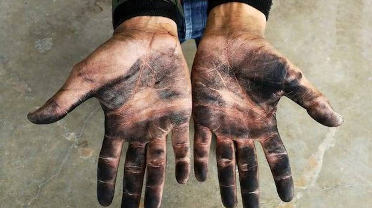 Soot on hands of a worker