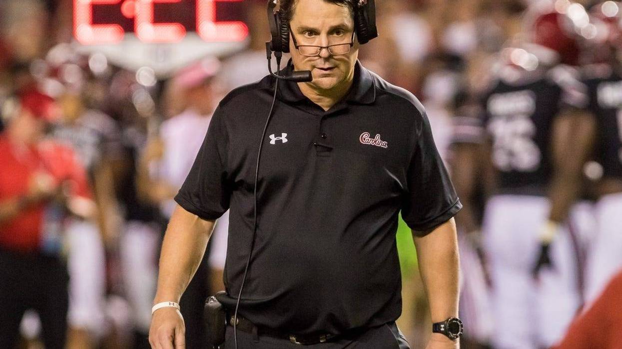 South Carolina Gamecocks head coach Will Muschamp checks on an injured player against the Kentucky Wildcats at Williams-Brice Stadium.