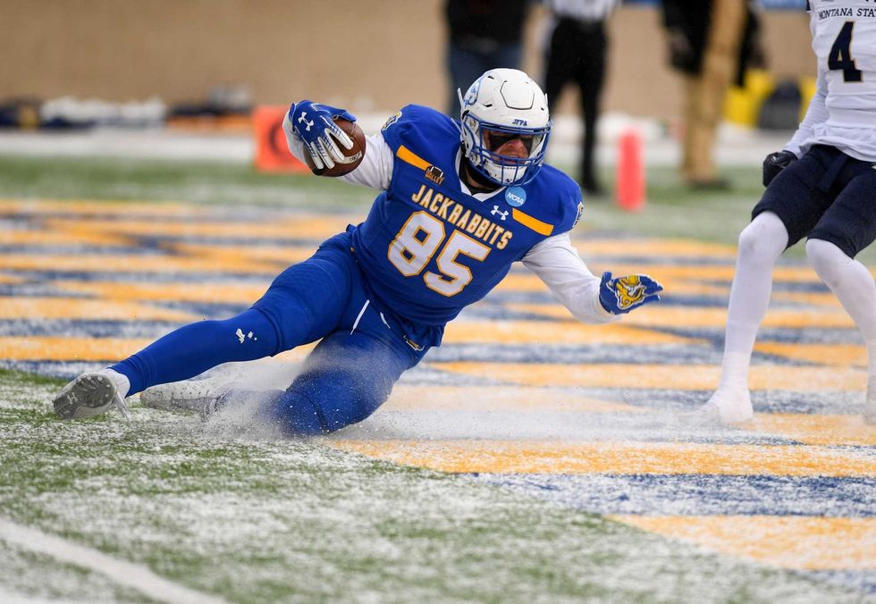 South Dakota State s Tucker Kraft uses the existing layer of snow to slide into the end zone for the first touchdown of the FCS semifinal game against Montana State on Saturday, December 17, 2022, at Dana J. Dykhouse Stadium in Brookings, SD