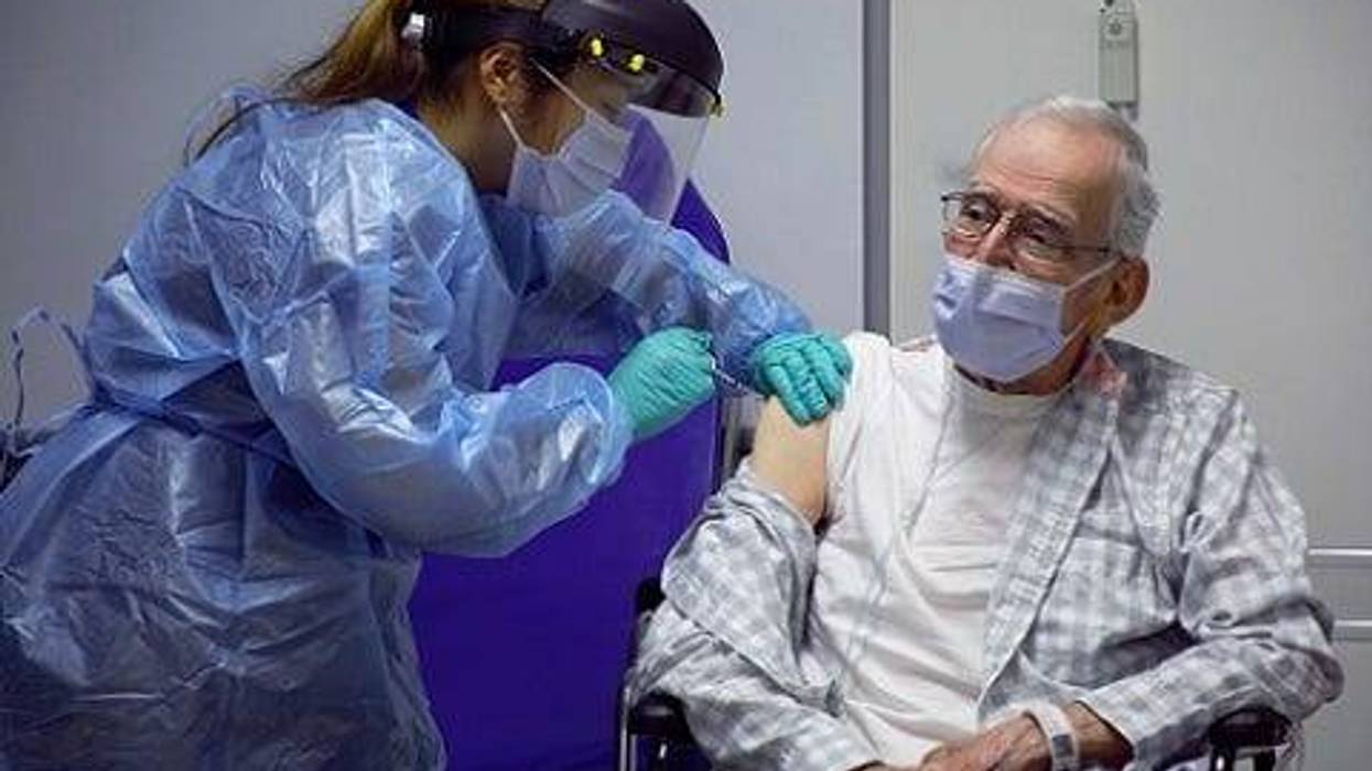 South Texas VA nurse, Christine Salonga vaccinates South Texas VA Community Living Center patient, Roy De La Garza, the first veteran to do so on Dec. 16.