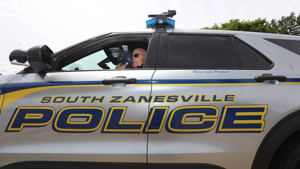 South Zanesville Police Chief Mark Ross monitors traffic on Maysville Pike. He said some money intended for equipment purchases is now going to the gas budget.