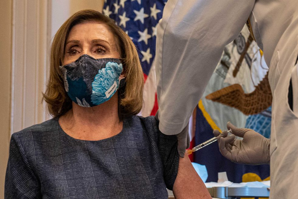 Speaker of the House Nancy Pelosi (D-CA) receives a COVID-19 vaccination shot by Dr. Brian Monahan (R), attending physician of the Congress of the United States, in her office on Capitol Hill on December 18, 2020 in Washington, DC.
