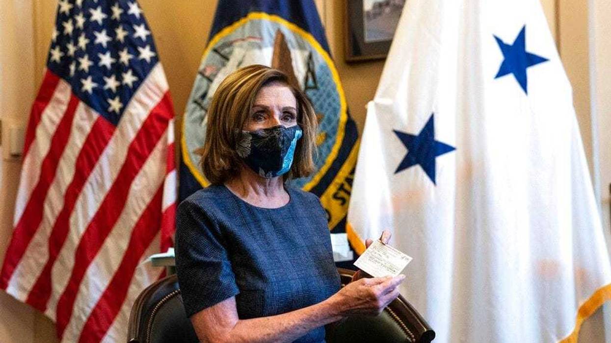 Speaker of the House Nancy Pelosi, D-Calif., sits after receiving a Pfizer-BioNTech COVID-19 vaccine shot in Washington, Friday, Dec. 18, 2020.