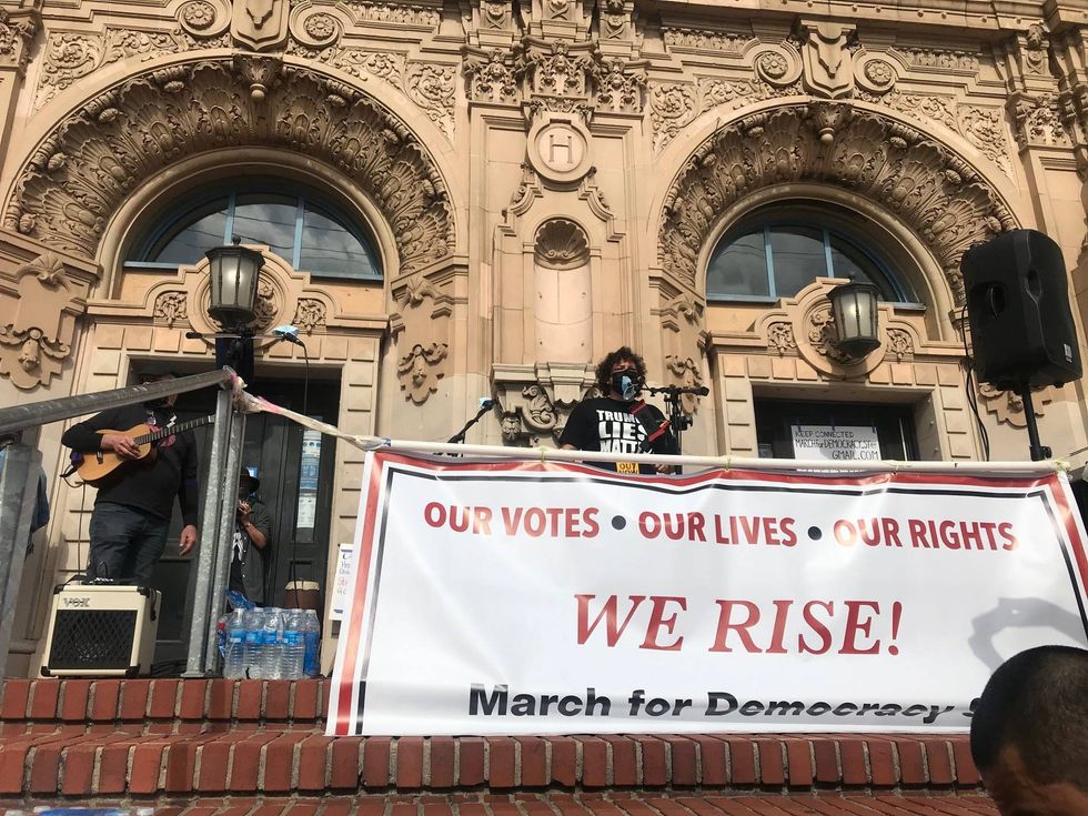 Speakers at a rally against President Trump