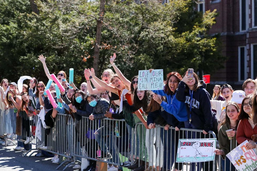 Spectators cheer on runners