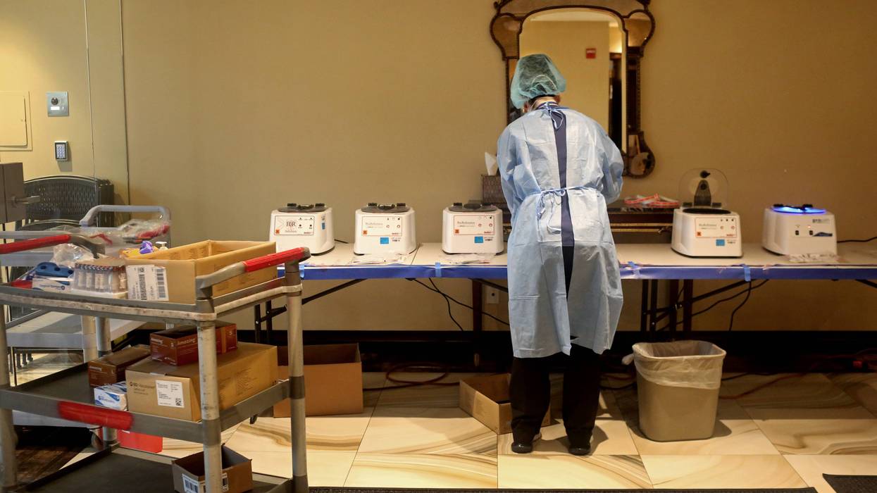 SPRING VALLEY, NY - APRIL 24: A phlebotomist processes specimens of people getting tested for coronavirus antibodies at the Refuah Health Center on April 24, 2020 in Spring Valley, New York.