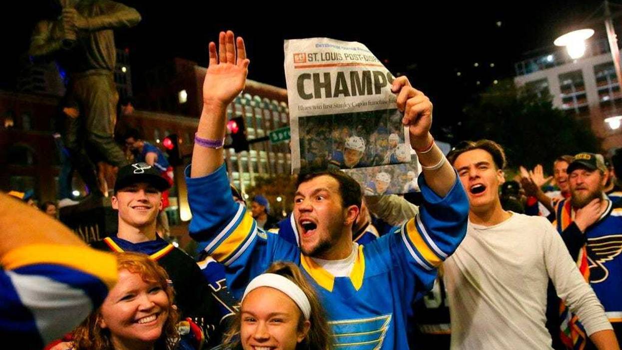 St. Louis Blues fans celebrate the team's victory over the Boston Bruins in Boston in Game 7 of the NHL hockey Stanley Cup Final, outside Busch Stadium in St. Louis after a watch party for the game was held in the baseball stadium Wednesday, June 12, 2019