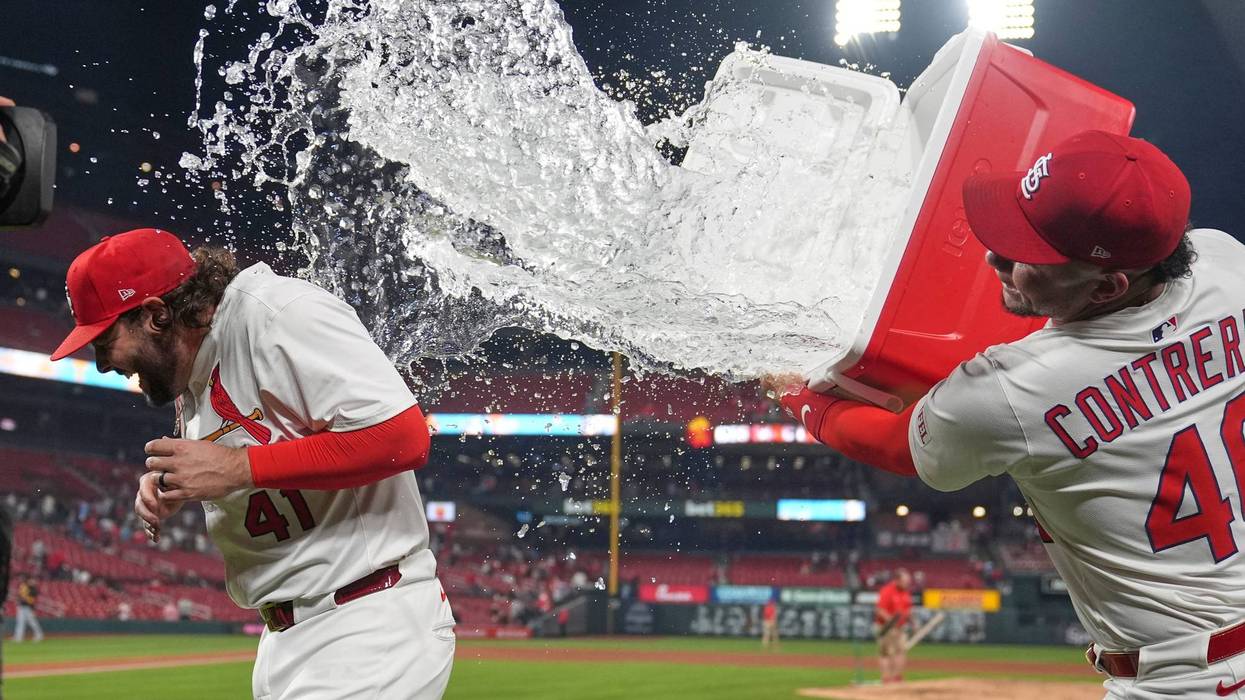 St. Louis Cardinals' Alec Burleson, left, is doused by teammate Willson Contreras following a baseball game against the Pittsburgh Pirates Tuesday, May 6, 2025, in St. Louis.