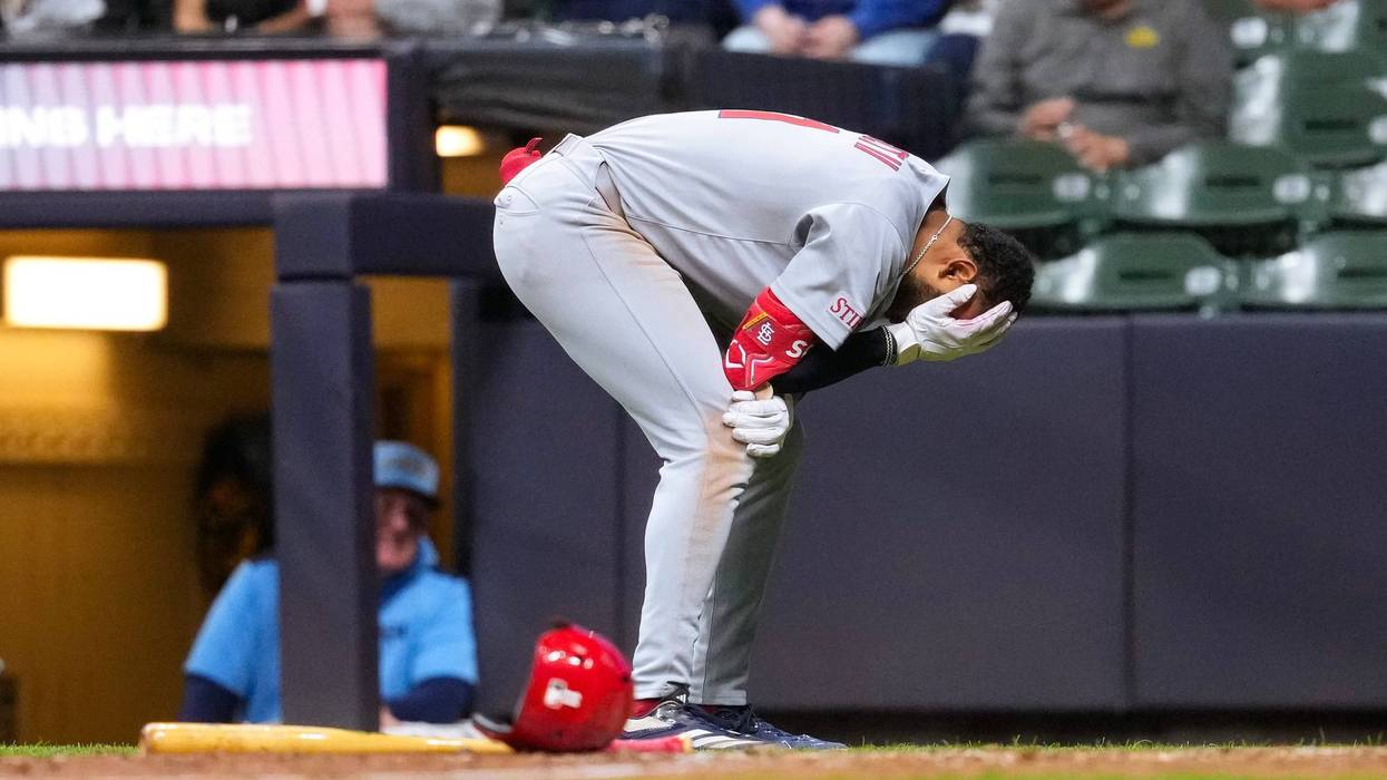 St. Louis Cardinals center fielder Victor Scott II (11) reacts after being hit in the helmet by a pitch during the eighth inning against the Milwaukee Brewers at American Family Field.