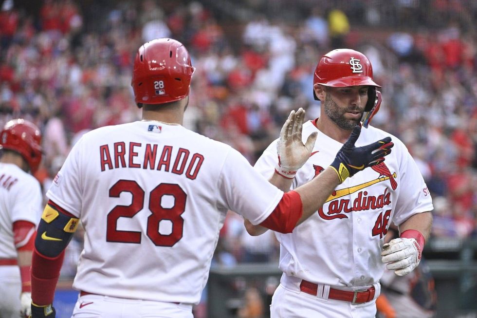 St. Louis Cardinals first baseman Paul Goldschmidt (46) is congratulated by St. Louis Cardinals third baseman Nolan Arenado (28) after Goldschmidt hits a solo home run against the Houston Astros in the second inning at Busch Stadium.