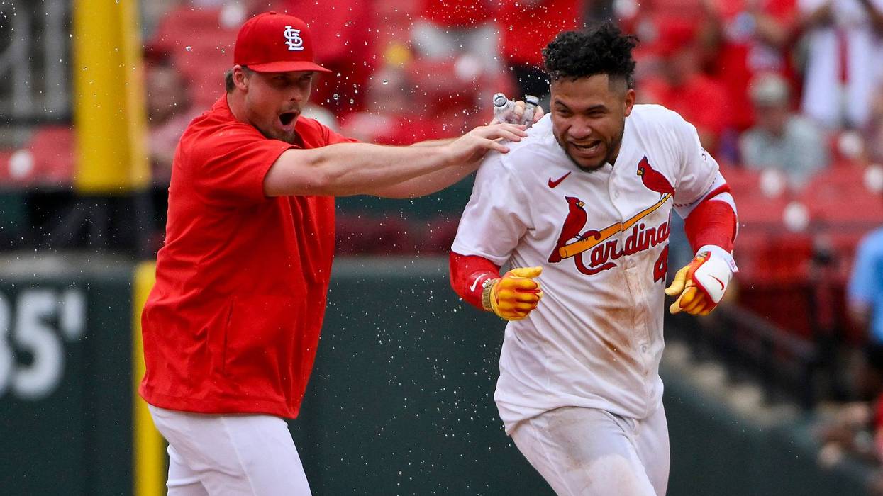 St. Louis Cardinals first baseman Willson Contreras (40) reacts as he is mobbed by Nolan Gorman (16) after hitting a walk-off one run single against the Kansas City Royals during the tenth inning at Busch Stadium.