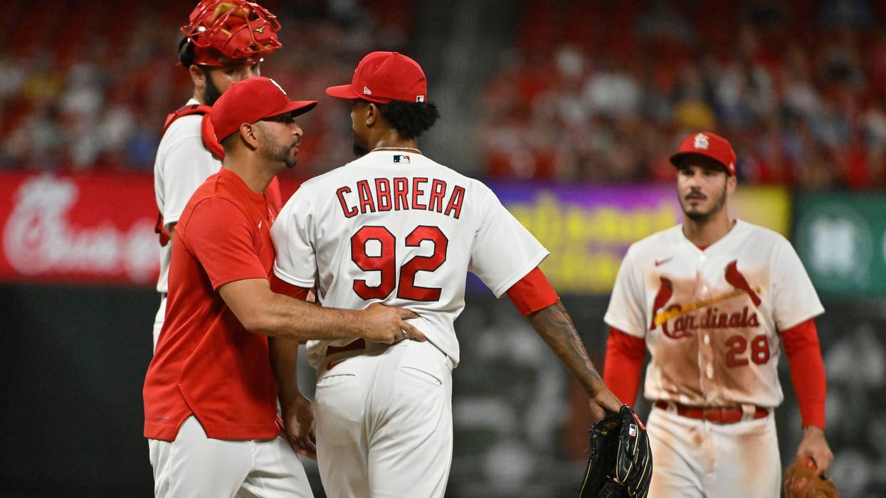 St. Louis Cardinals manager Oliver Marmol (37) talks with relief pitcher Genesis Cabrera (92) as he removes him from the game during the ninth inning against the Cincinnati Reds at Busch Stadium.