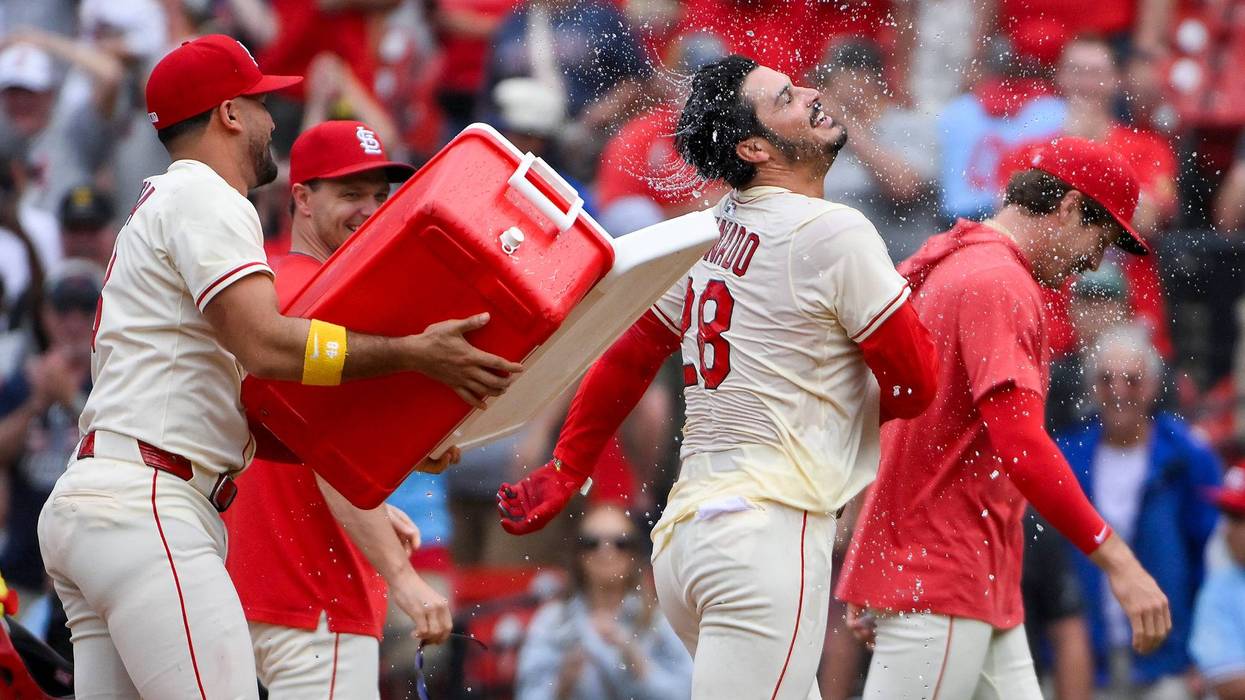 St. Louis Cardinals pinch hitter Nolan Arenado (28) is doused with water and mobbed by teammates after hitting a walk-off one run single against the Los Angeles Dodgers during the ninth inning at Busch Stadium.