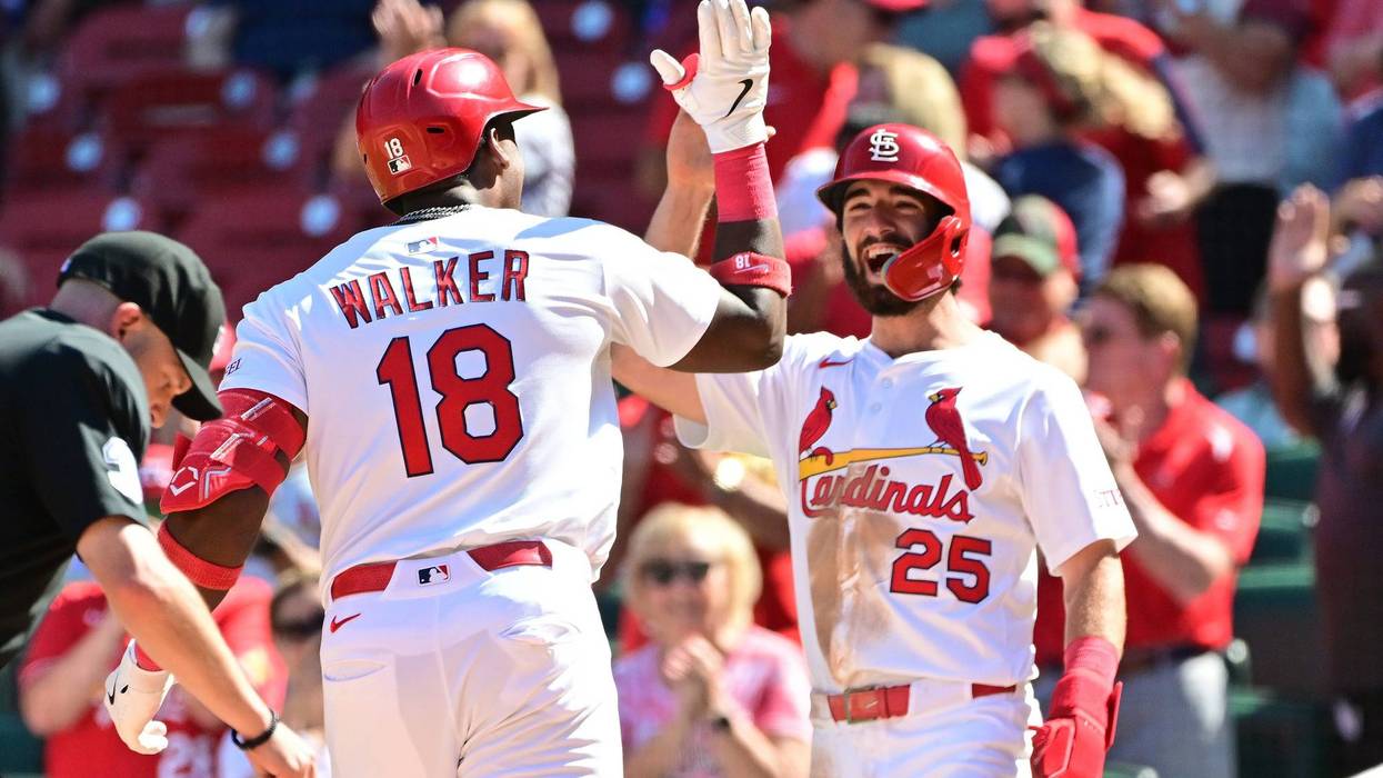 St. Louis Cardinals right fielder Jordan Walker (18) is greeted at home plate by second baseman Thomas Saggese (25) after Walker hit a two-run home run in the seventh inning against the Pittsburgh Pirates at Busch Stadium.