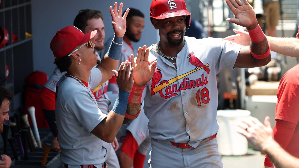 St. Louis Cardinals right fielder Jordan Walker (18) is greeted in the dugout after scoring a run during the third inning against the Los Angeles Dodgers at Dodger Stadium.
