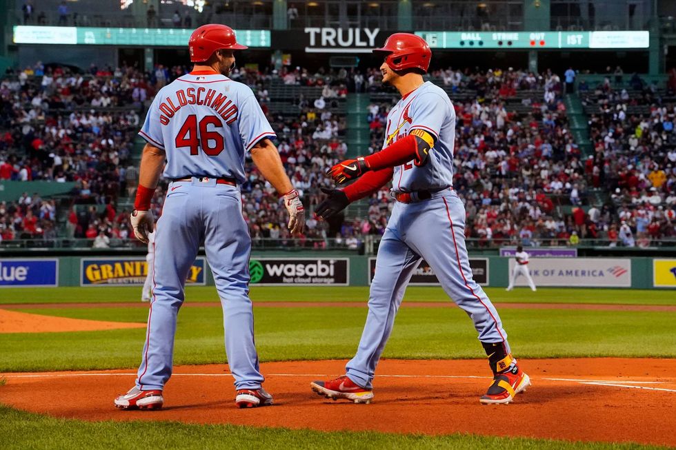 St. Louis Cardinals third baseman Nolan Arenado (right) celebrates with first baseman Paul Goldschmidt (46) after hitting a two run home run against the Boston Red Sox during the first inning at Fenway Park.