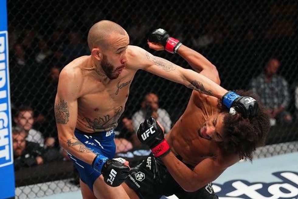 ST LOUIS, MISSOURI - MAY 11: (L-R) Sean Woodson punches Alex Caceres in a featherweight fight during the UFC Fight Night event at Enterprise Center on May 11, 2024 in St Louis, Missouri. (Photo by Josh Hedges/Zuffa LLC via Getty Images)