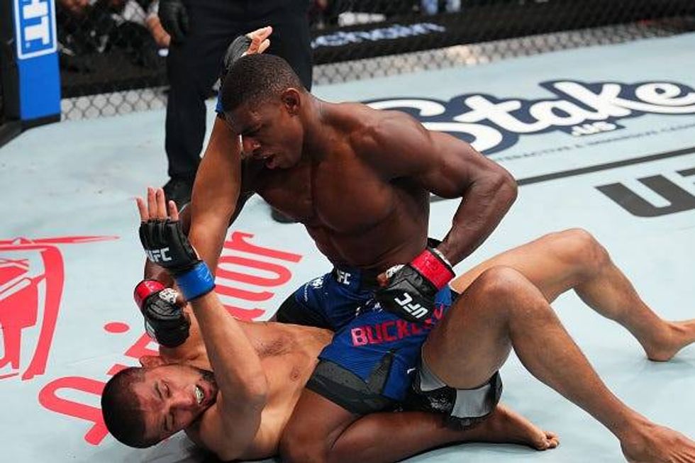 ST LOUIS, MISSOURI - MAY 11: (R-L) Joaquin Buckley punches Nursulton Ruziboev of Uzbekistan in a welterweight fight during the UFC Fight Night event at Enterprise Center on May 11, 2024 in St Louis, Missouri. (Photo by Josh Hedges/Zuffa LLC via Getty Images)