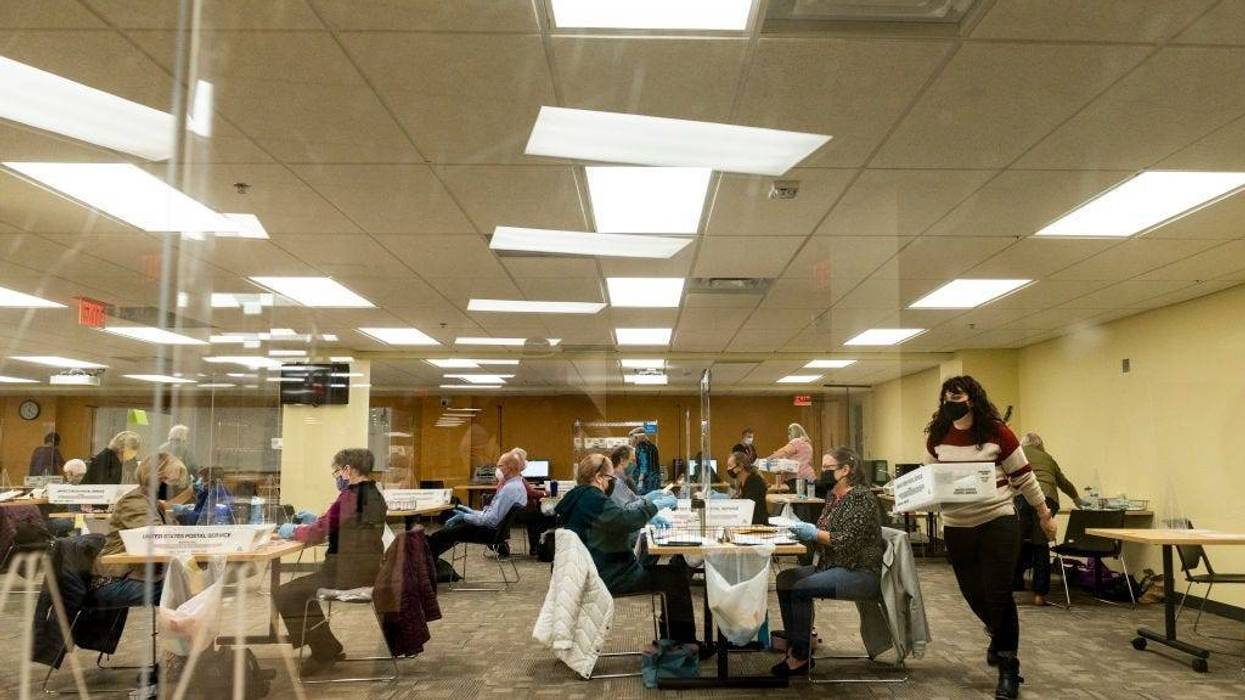 ST PAUL, MN - NOVEMBER 02: Volunteers and election officials process absentee ballots at Ramsey County's absentee ballot count center on November 2, 2020 in St Paul, Minnesota.