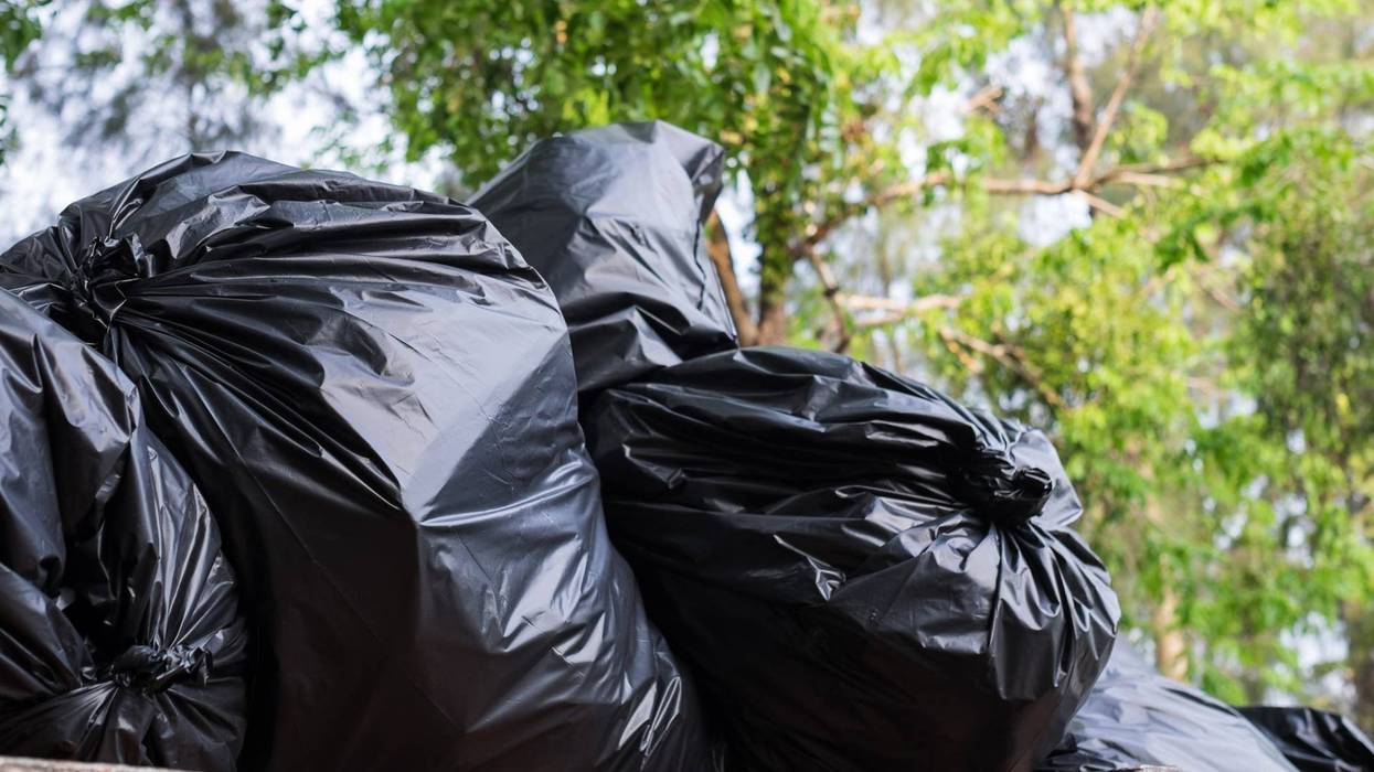 stacks of filled black trash bags
