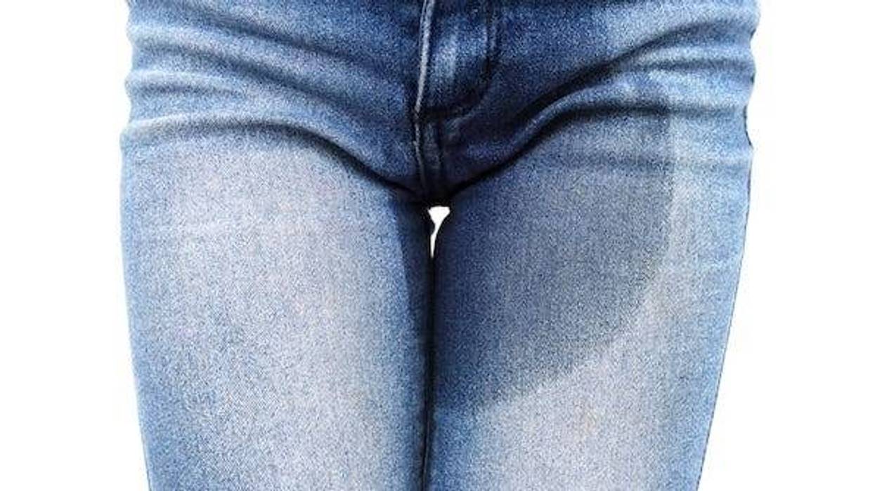 Stained blue jeans against white background