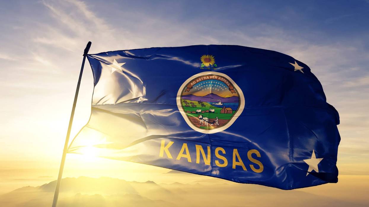 State of Kansas flag on flagpole textile cloth fabric waving