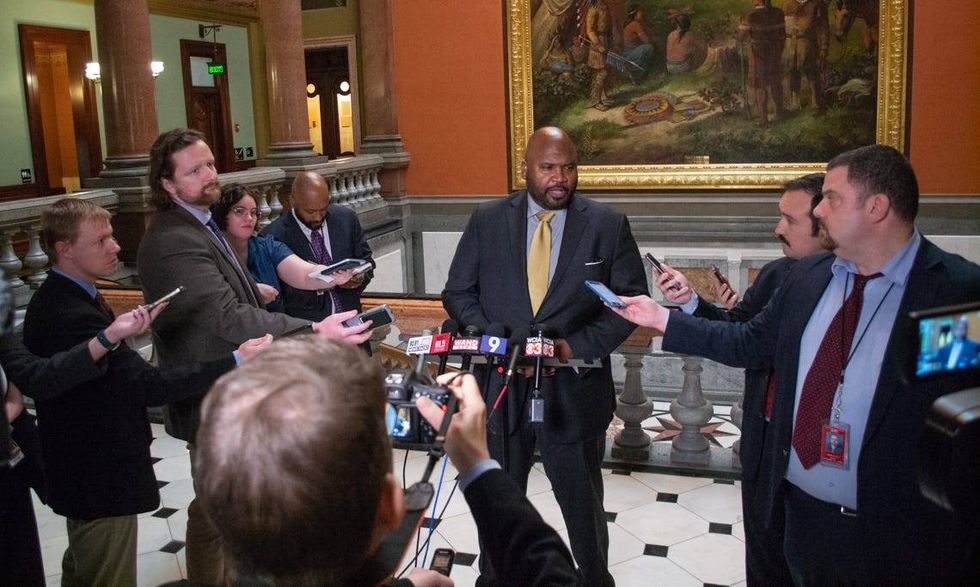 State Sen. Elgie Sims, D-Chicago, talks to reporters in the Capitol rotunda.