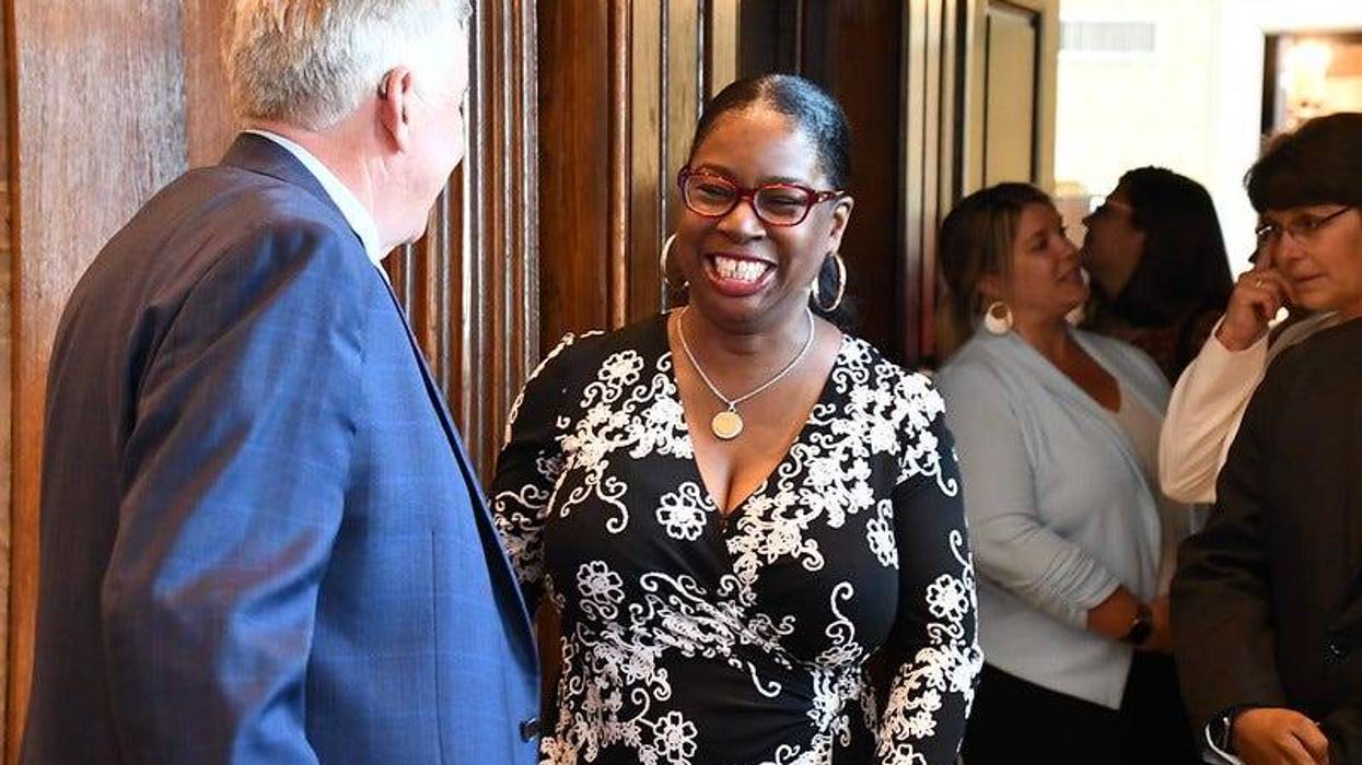 State Sen. Karla May, D-St. Louis, talks with Gov. Mike Parson at a 2021 bill signing ceremony.