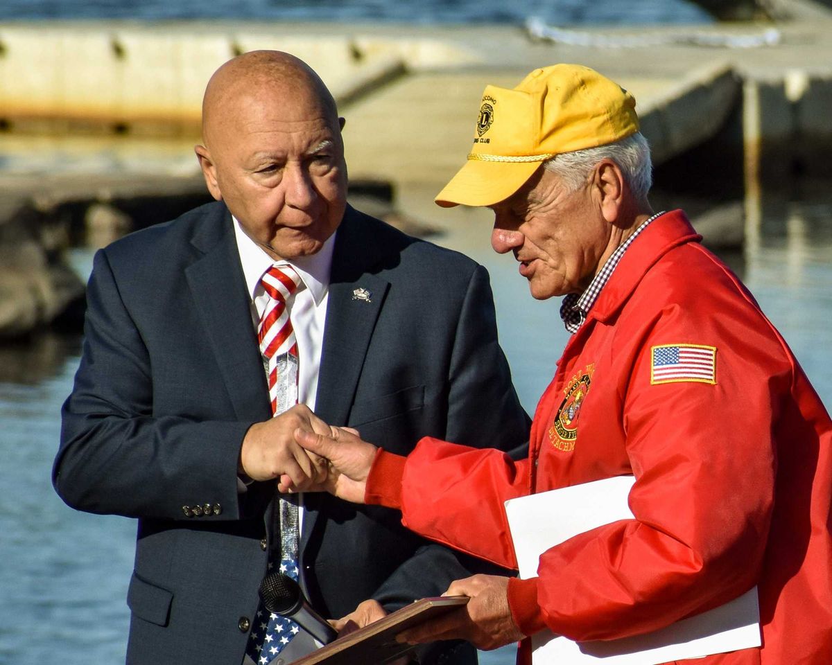 State Sen. Mario Scavello shakes hands with Pocono Lions Club president Mike Kummer at Lake Naomi in Pocono Pines on Saturday, Sept. 11, 2021. Lake Naomi Club and the Pocono Lions Club hosted a ceremony commemorating the 20th anniversary of the Sept. 11 attacks. Piscani Npor 091121 Lakenaomisept11ceremony 12
