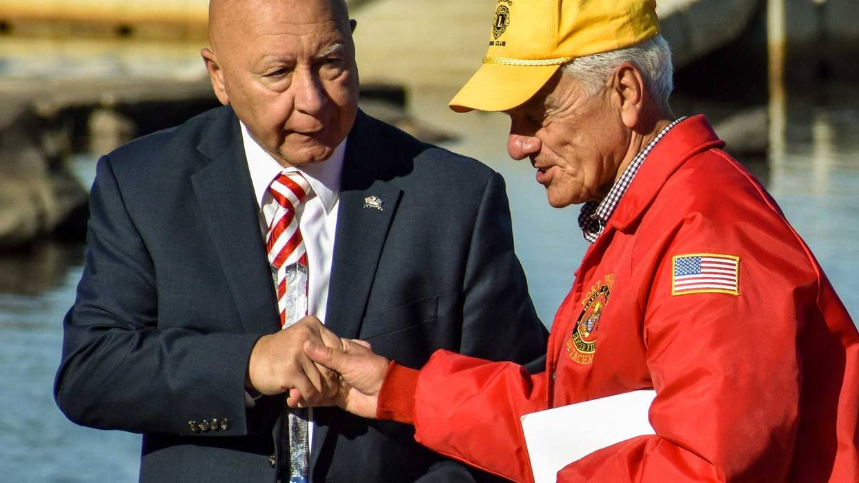 State Sen. Mario Scavello shakes hands with Pocono Lions Club president Mike Kummer at Lake Naomi in Pocono Pines on Saturday, Sept. 11, 2021. Lake Naomi Club and the Pocono Lions Club hosted a ceremony commemorating the 20th anniversary of the Sept. 11 attacks. Piscani Npor 091121 Lakenaomisept11ceremony 12
