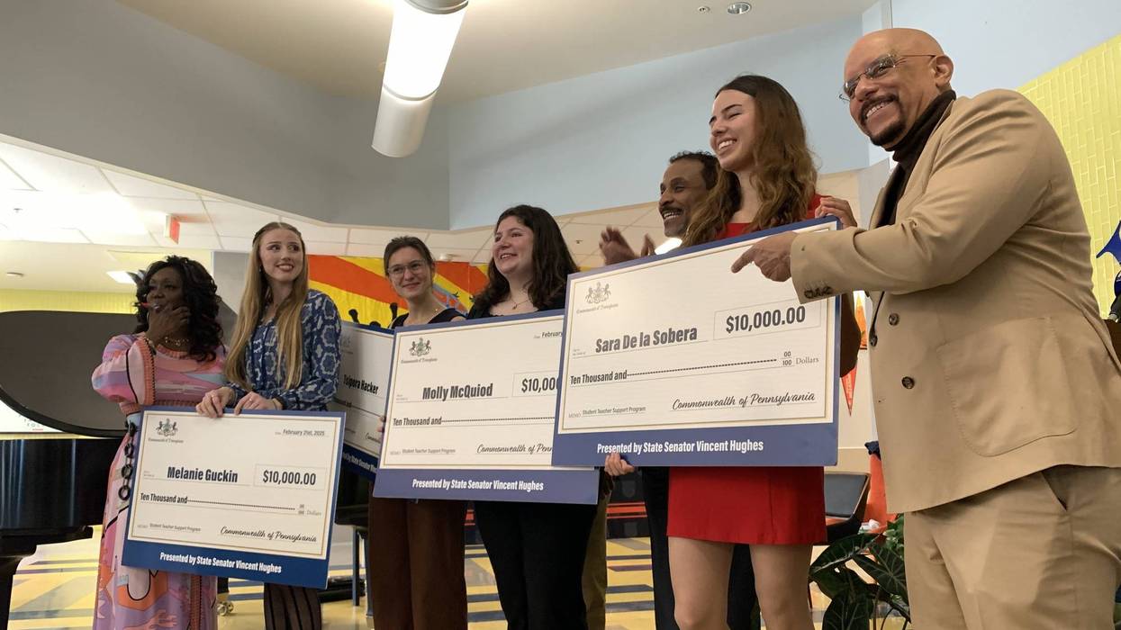 State Sen. Vincent Hughes (right) and School District of Philadelphia Superintendent Tony Watlington (2nd from right) present student teachers with $10,000 stipend checks at West Philadelphia High School on Friday, Feb. 21.
