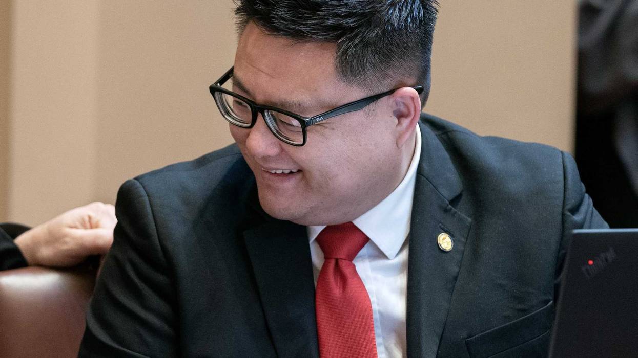State Senator Tou Xiong discusses senate business during a floor session.