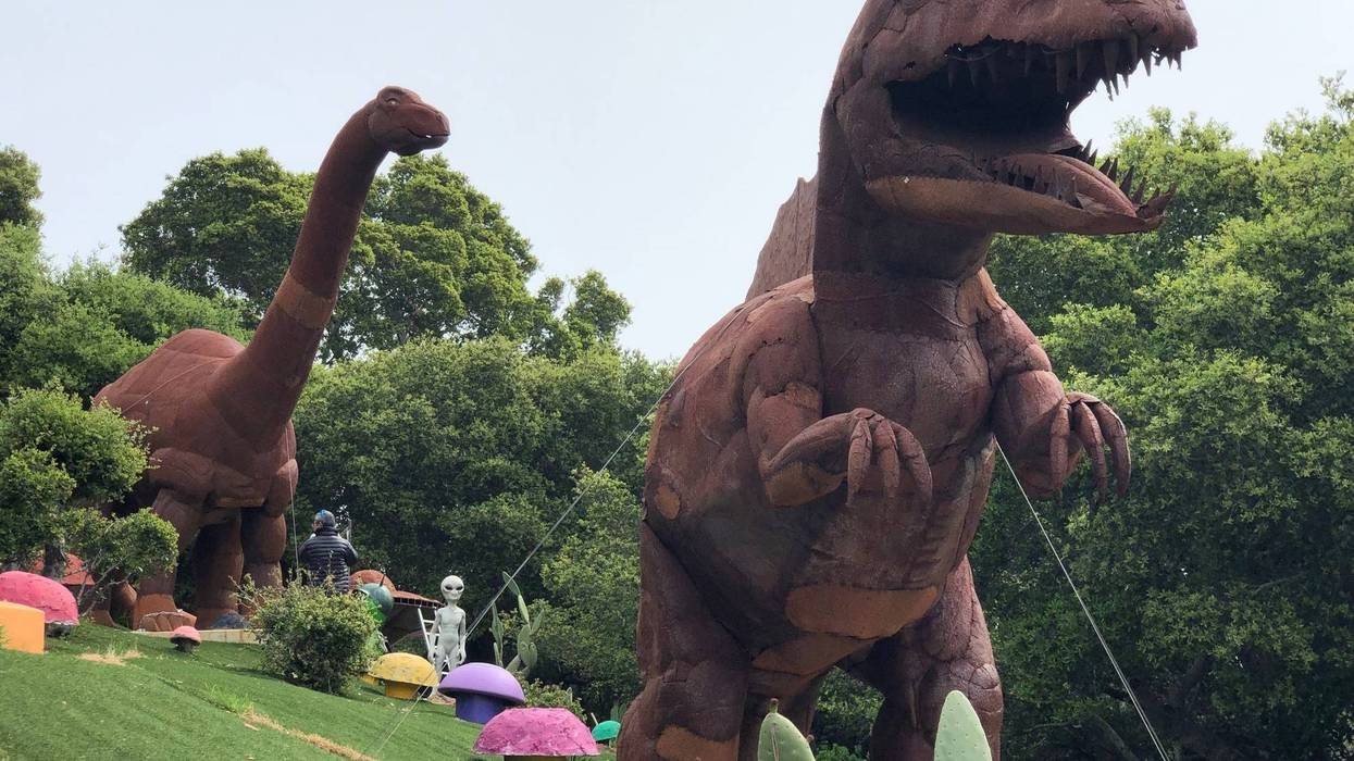 Statues of dinosaurs are among the many decorations in the yard of the Flintstone house of Hillsborough.
