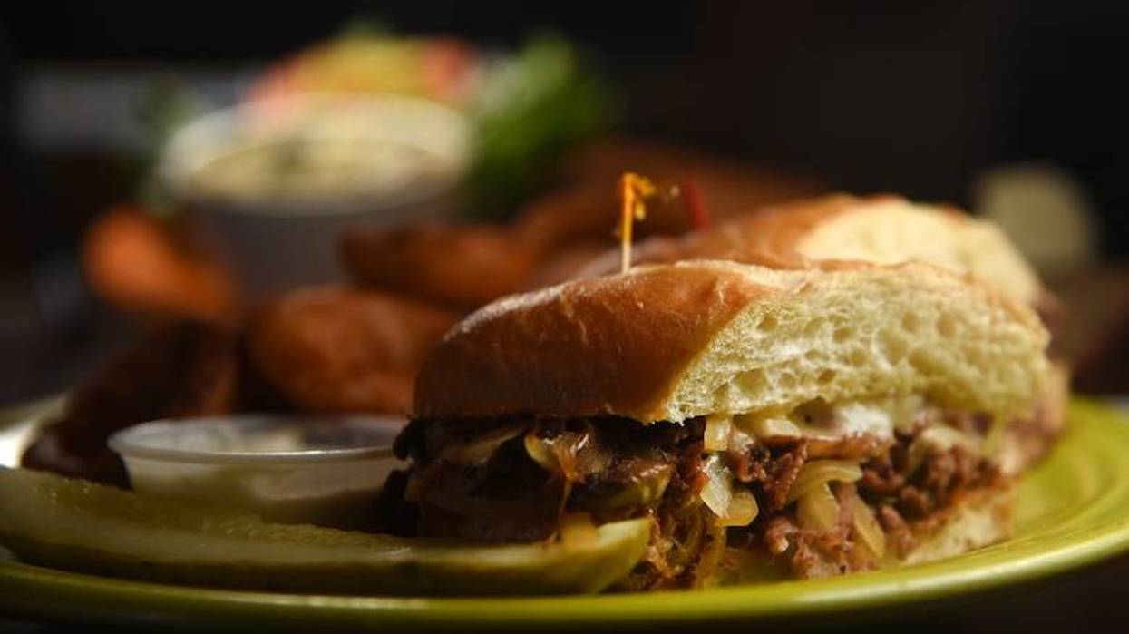 Steak sandwich with onion rings on a plate