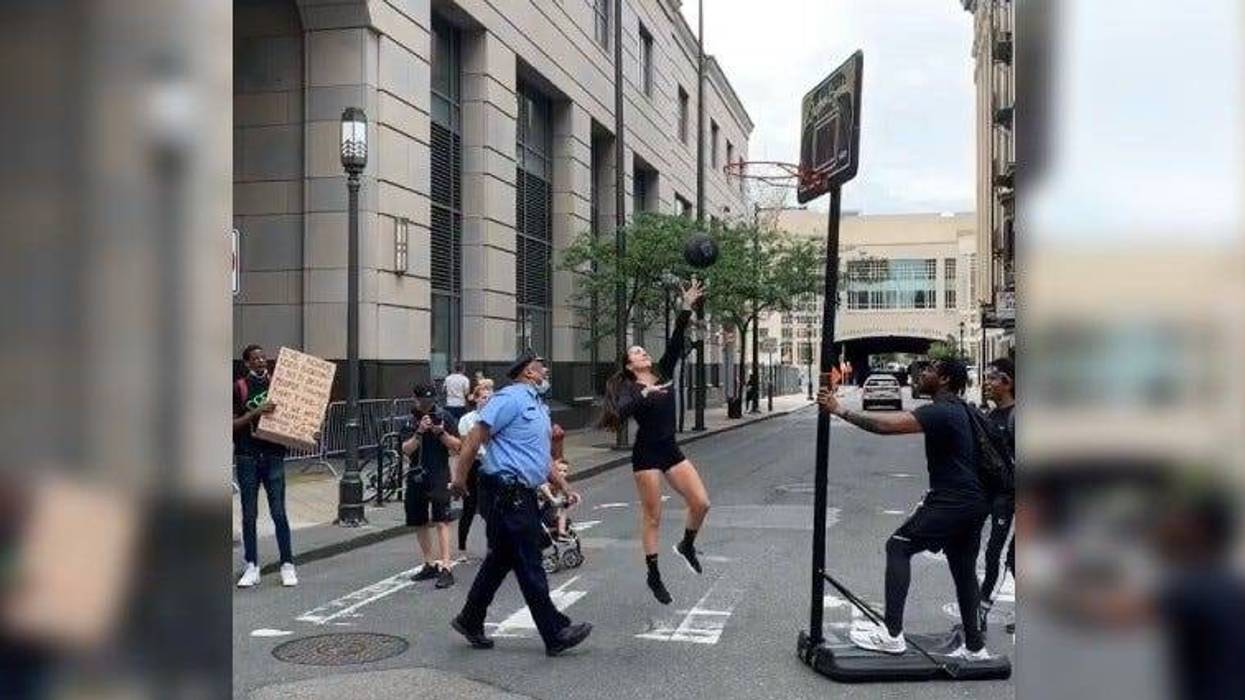 Stephania Ergemlidze playing basketball with a police officer