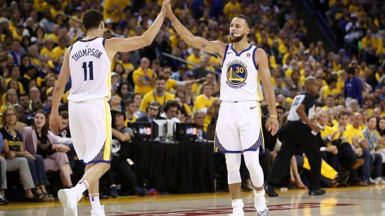 Stephen Curry #30 and Klay Thompson #11 of the Golden State Warriors react after a plat against the Houston Rockets during Game Three of the Western Conference Finals of the 2018 NBA Playoffs at ORACLE Arena on May 20, 2018 in Oakland, California.