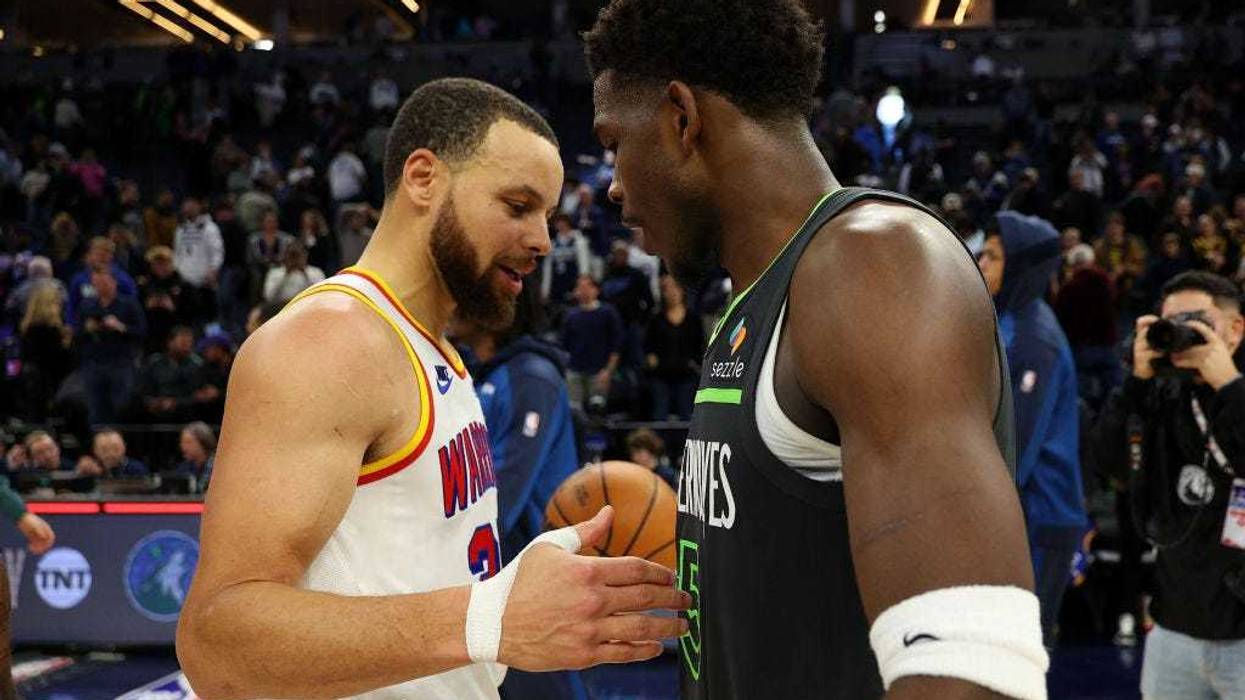 Stephen Curry #30 of the Golden State Warriors and Anthony Edwards #5 of the Minnesota Timberwolves shake hands after the game at Target Center on January 15, 2025 in Minneapolis, Minnesota. The Warriors defeated the Timberwolves 116-115.