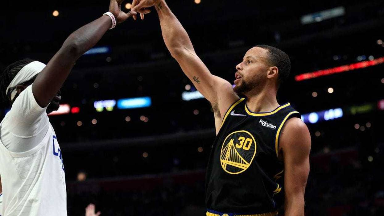 Stephen Curry #30 of the Golden State Warriors celebrates scoring a three-point basket against the Los Angeles Clippers during the second half of the game at Staples Center on November 28, 2021 in Los Angeles, California.