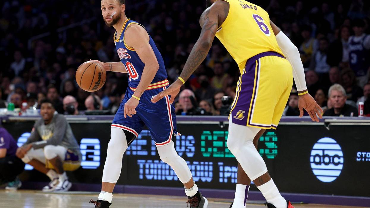 Stephen Curry #30 of the Golden State Warriors dribbles in front of LeBron James #6 of the Los Angeles Lakers during a 124-116 Lakers win at Crypto.com Arena on March 05, 2022 in Los Angeles, California.