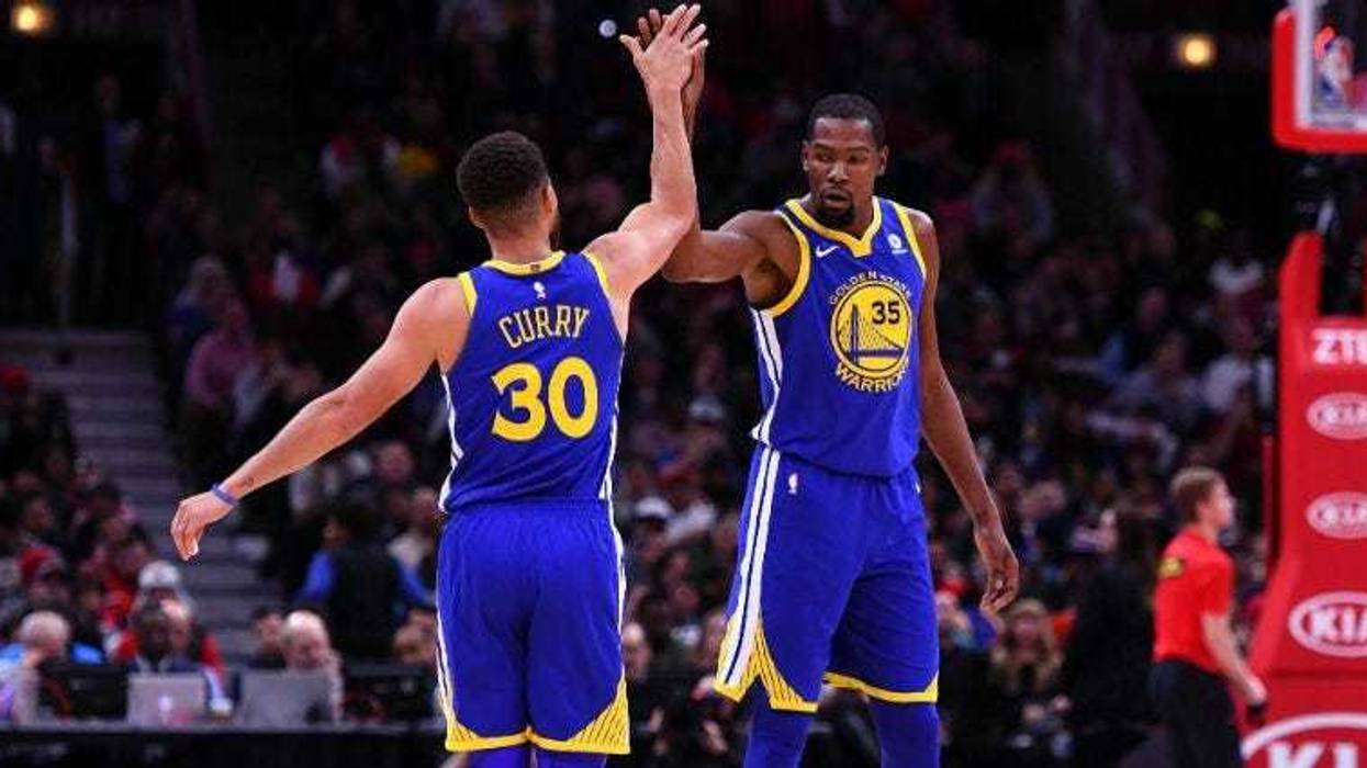 Stephen Curry reacts with Kevin Durant after making a three point basket against the Chicago Bulls during the second half at the United Center in Chicago.