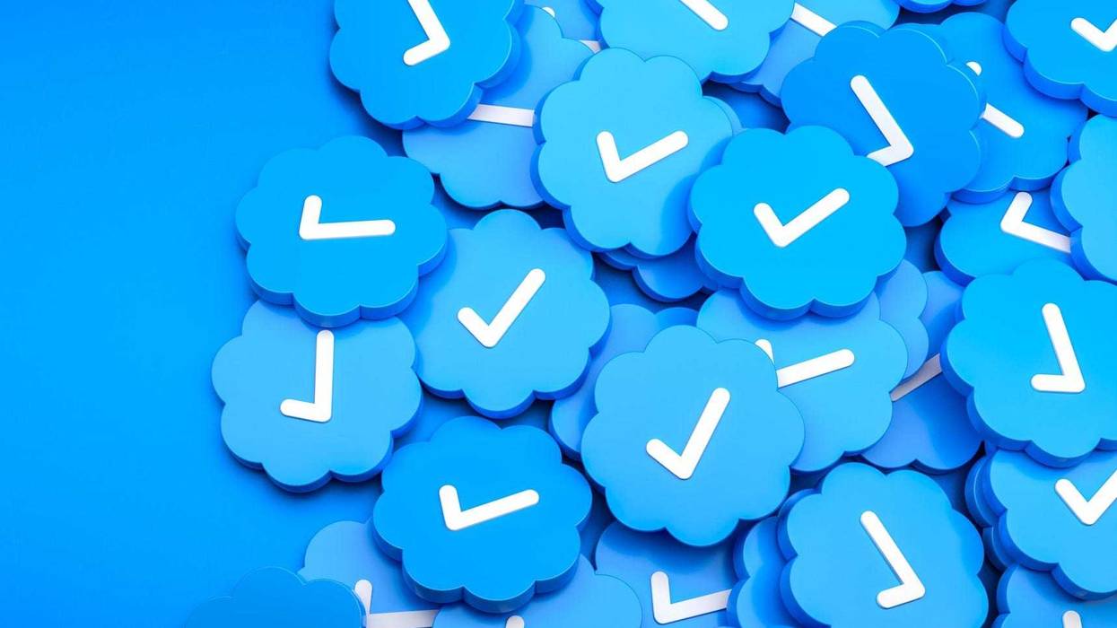Stock art concept -- a pile of blue check marks such as those seen on Twitter.