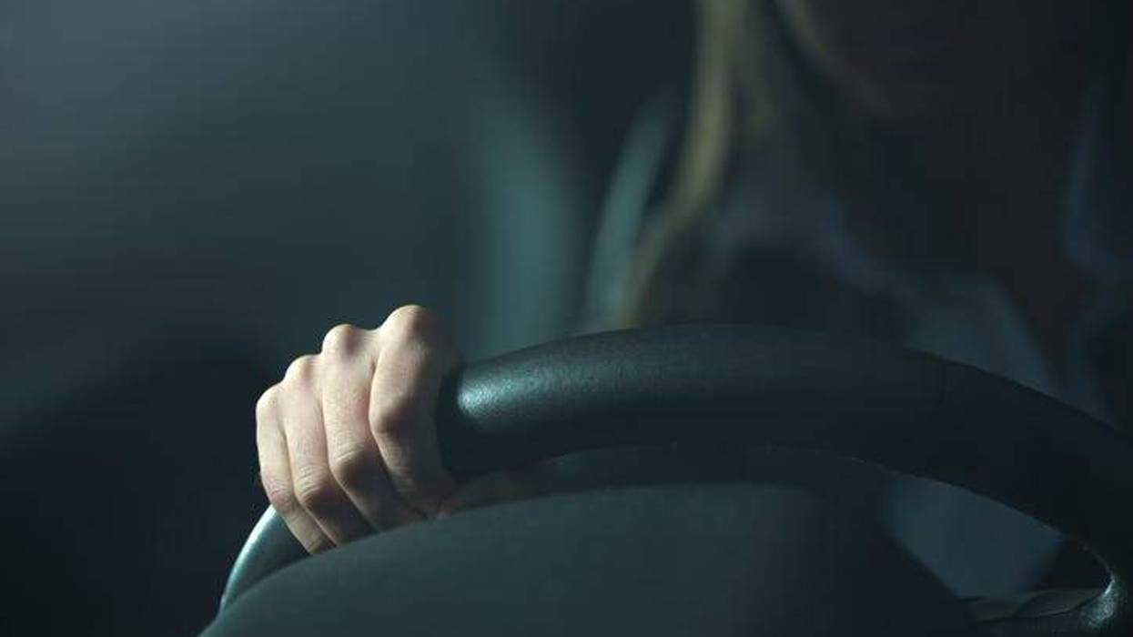 Stock image of a woman driving.