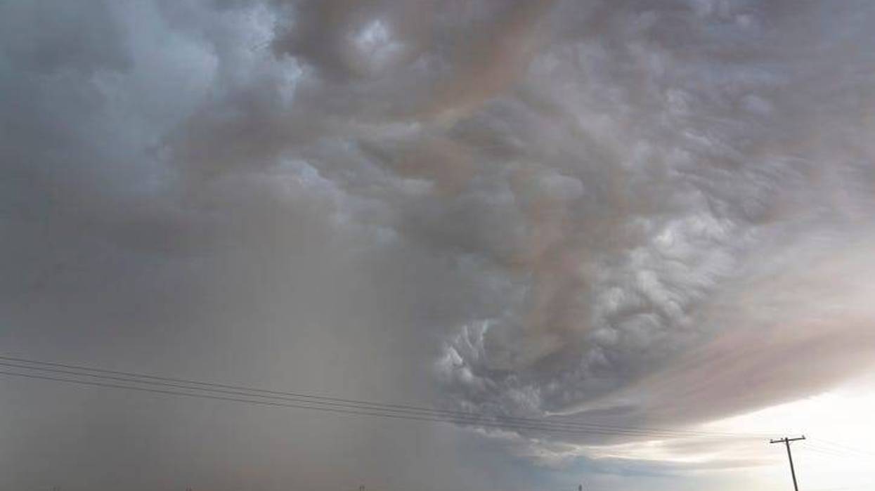 Stock photo of a tornado forming over a field.
